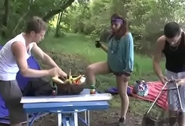A girl fucked hard by two guys in a camping